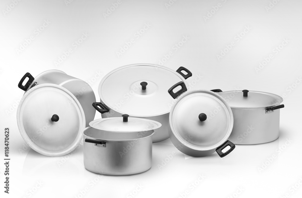 several cooking pots on a light background several cooking pots on a light background