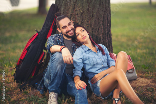 Loving couple holding each other sitting on a tree trunk  © Mediteraneo