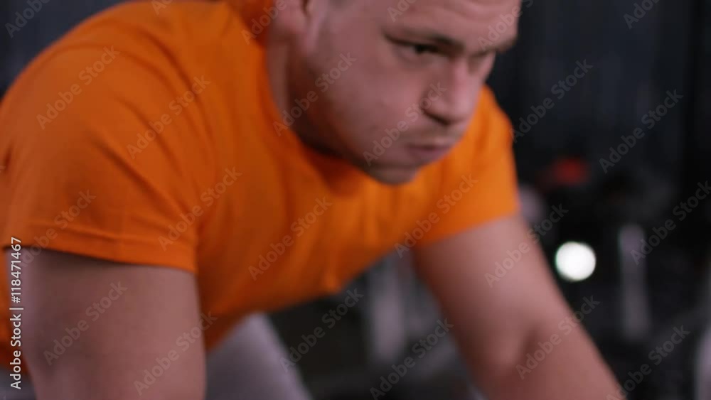 Close up of man with prosthetic leg working out on exercise bike at the gym. Close up of man with prosthetic leg working out on exercise bike at the gym.