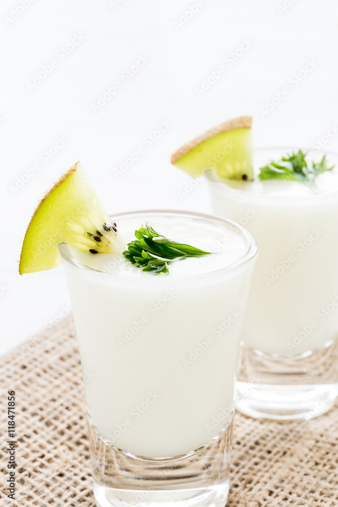 Yogurt mix with green kiwi on white background Yogurt mix with green kiwi on white background