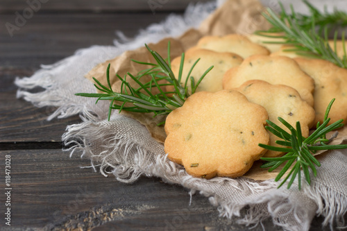 Delicious freshly baked homemade cookies with rosemary on a wooden surface, rustic style, selective focus