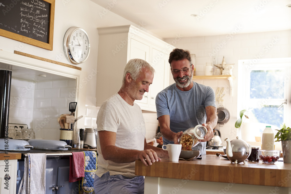 Male gay couple looking at breakfast cereal in their kitchen Male gay couple looking at breakfast cereal in their kitchen