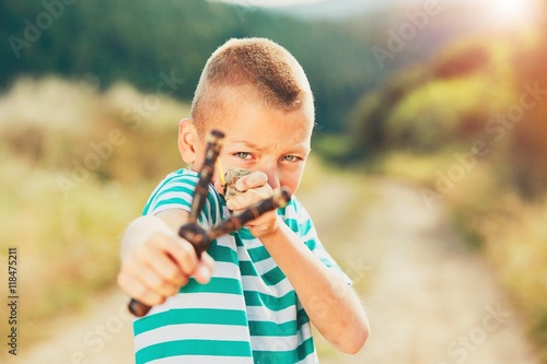 Vászonkép Boy with slingshot