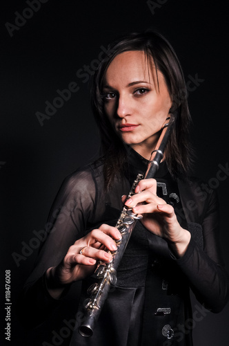 a young girl playing the flute