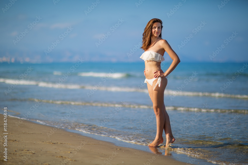 Young beautiful woman has fun at the sea in summertime Young beautiful woman has fun at the sea in summertime