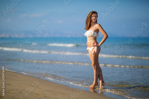 Young beautiful woman has fun at the sea in summertime