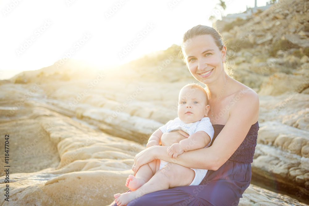 Mother and her son have great time at the seashore at sunset Mother and her son have great time at the seashore at sunset