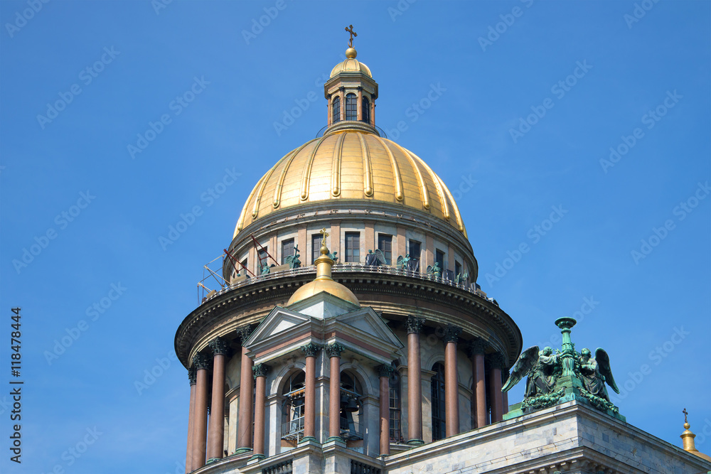 The Dome of St. Isaac's Cathedral on a background of blue summer sky close-up. Saint Petersburg