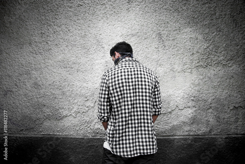 Gangster in black bandana near the wall