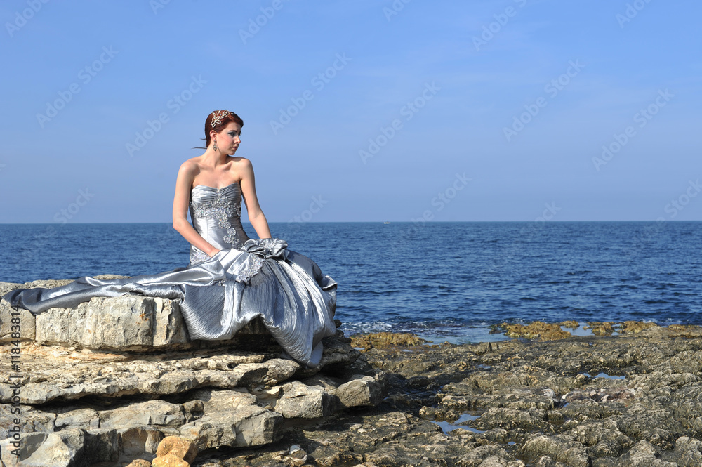 beautiful young fashion model posing on nature with fashion dress