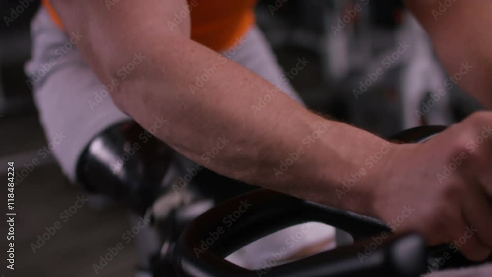 Close up of man with prosthetic leg working out on exercise bike at the gym. Close up of man with prosthetic leg working out on exercise bike at the gym.
