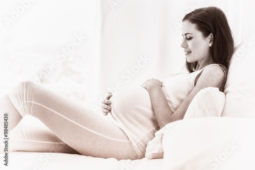 Happy pregnancy sitting on sofa 