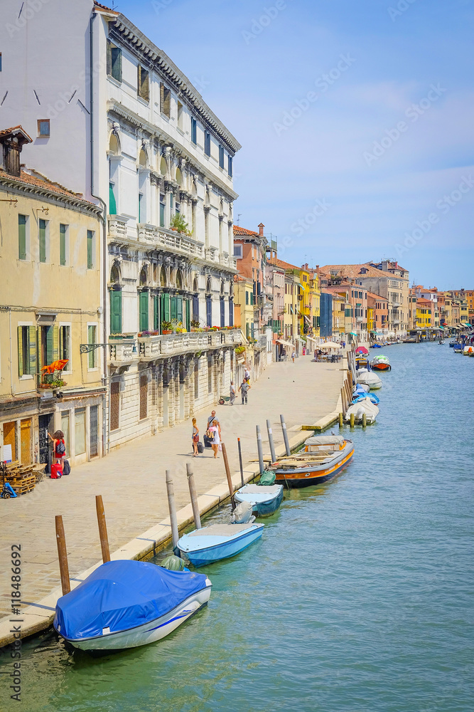 Fototapeta premium Venice, Italy, June, 21, 2016: landscape with the image of boats on a channel in Venice, Italy