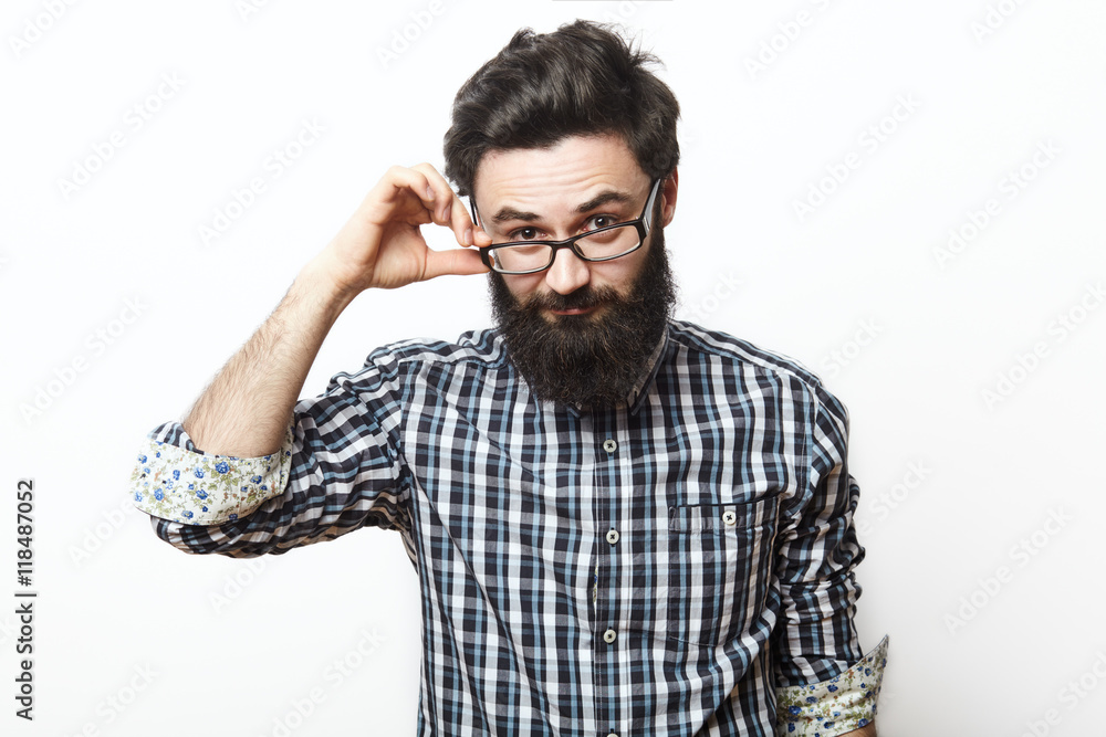 young nerd bearded businessman touching his glasses young nerd bearded businessman touching his glasses