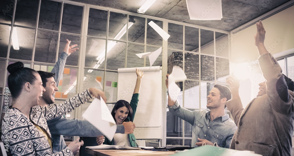 Celebrating business people throwing papers in the air Celebrating business people throwing papers in the air
