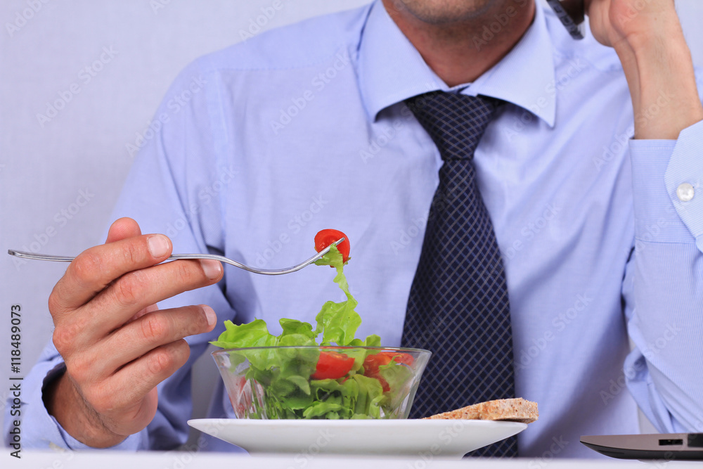 Businessman eating healthy meal in office close up. Healthy lifestyle concept Businessman eating healthy meal in office close up. Healthy lifestyle concept