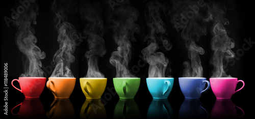 Hot drink mug the rainbows color placed on colour black background