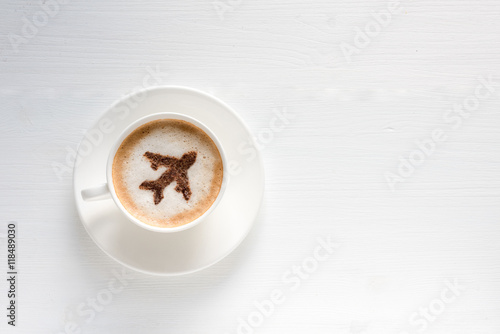 Airplane made of cinnamon in coffee. Cup of coffee with aircraft. Traveling concept. Cappuccino in airport