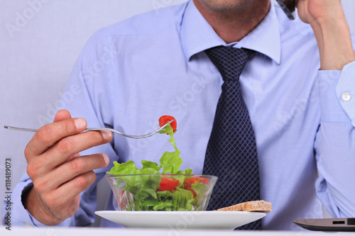 Businessman eating healthy meal in office close up. Healthy lifestyle concept