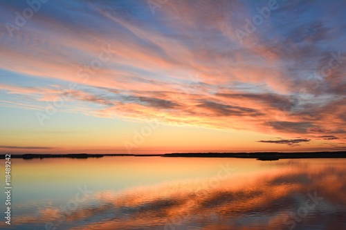 Sunrise sky with clouds reflected in the water