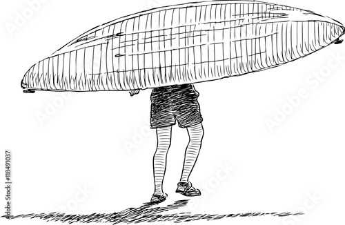 man carries kayak in water