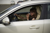 woman drinks coffee in the car