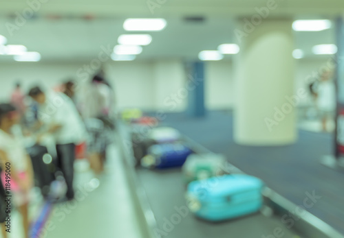 Blurred image of luggage carousel at baggage claim in airport.