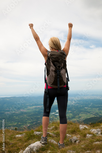 Trekking - woman hiking in mountains on a calm sumer day being
