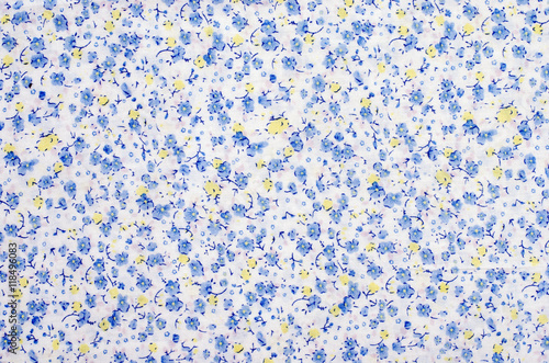 Floral pattern on fabric. Blue and yellow flowers print on white background.