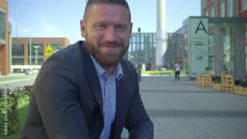 Wallpaper Mural Businessman browsing tablet. He is sitting at the table during break of the work. He is young and has beard. Man is dressed in suit and shirt.
 Torontodigital.ca