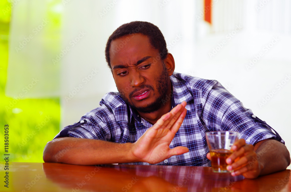 Handsome man wearing white blue shirt sitting by bar counter lying over desk expressing no desire to keep drinking using body language, drunk depressed facial expression, alcoholic concept Handsome man wearing white blue shirt sitting by bar counter lying over desk expressing no desire to keep drinking using body language, drunk depressed facial expression, alcoholic concept