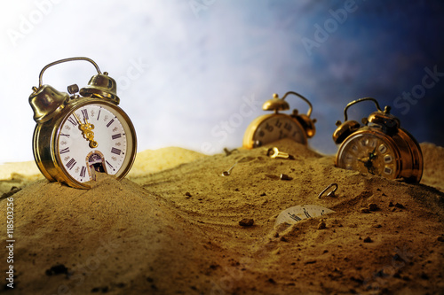 Fotografie sand running out of an alarm clock, other watches sink into it, surreal time con