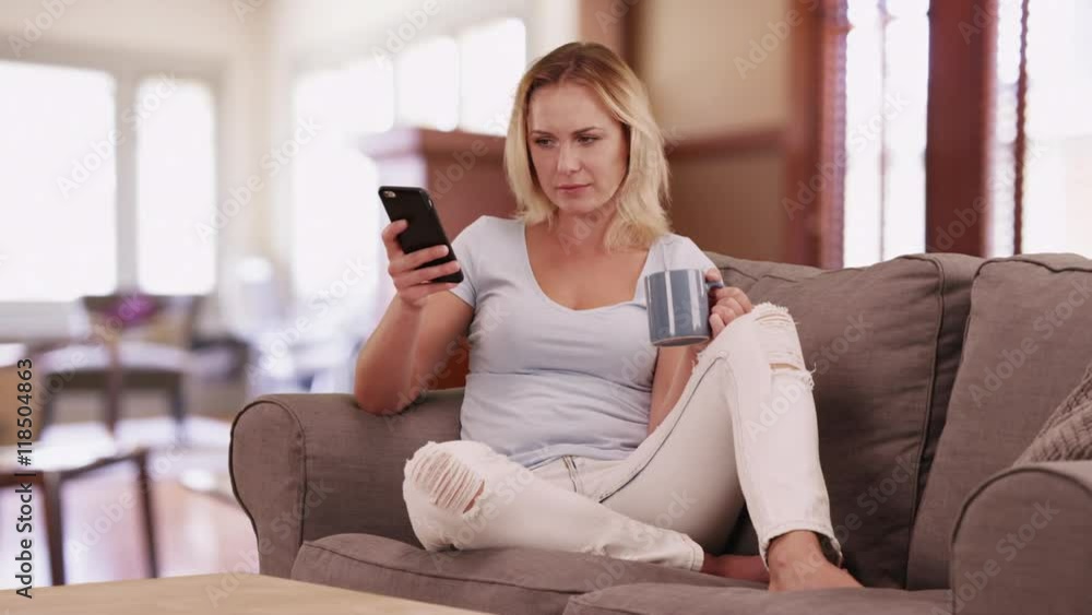 Happy woman using smartphone at home Happy woman using smartphone at home