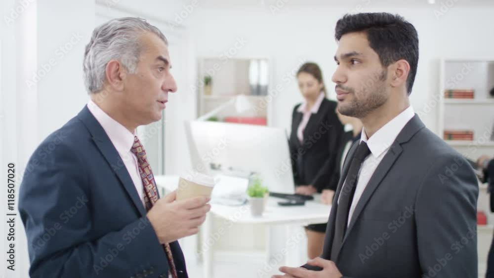 Arab businessmen having a serious conversation in office Arab businessmen having a serious conversation in office