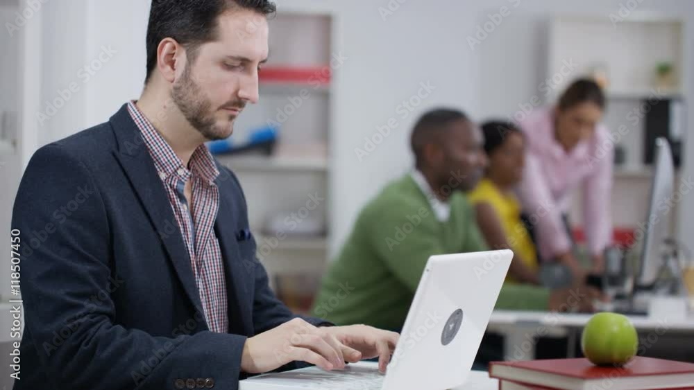 Portrait of smiling businessman working on laptop Portrait of smiling businessman working on laptop