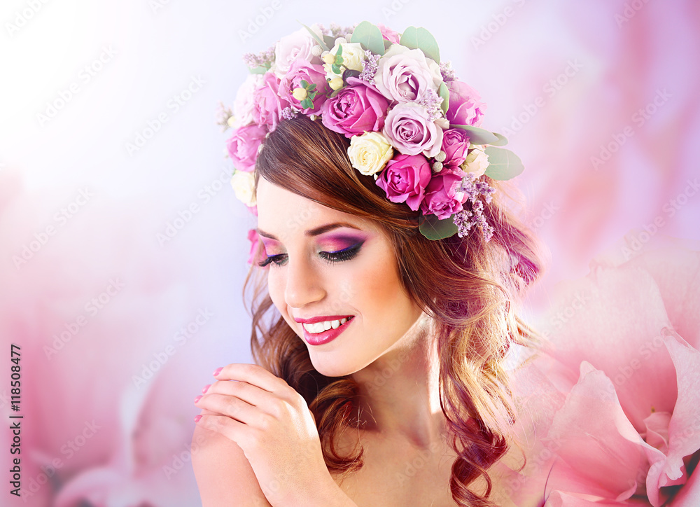 Beautiful young woman wearing floral headband on a purple background