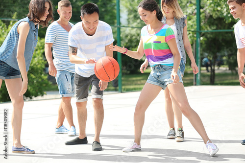 Teenagers playing basketball