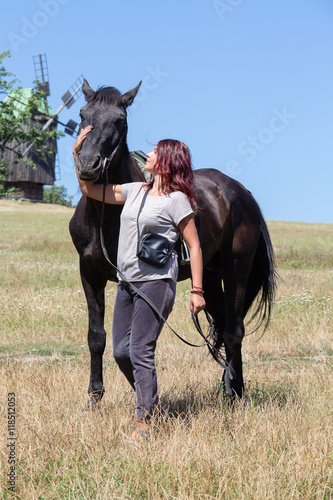 Beautiful girl and black horse in nature. Kiev, Ukraine © OlegD