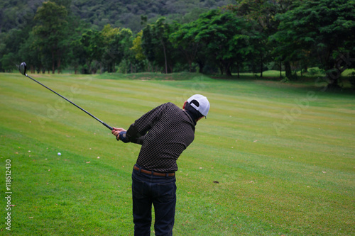 Male golf player in Golf court is Surrounded natural 