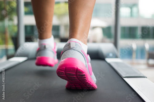 Jogging on treadmill, focus on the treadmill, blurred motion 