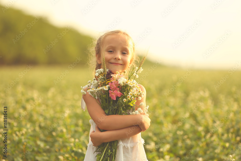 Happy little girl with flowers in the field Happy little girl with flowers in the field