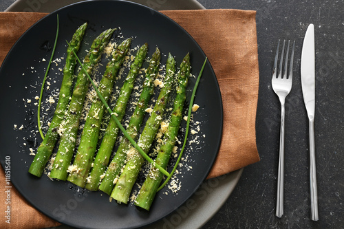 Grilled asparagus on black plate