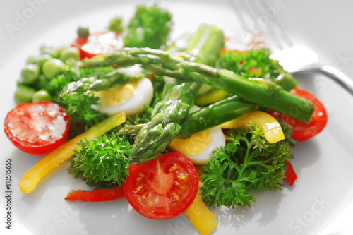Asparagus with vegetables on plate