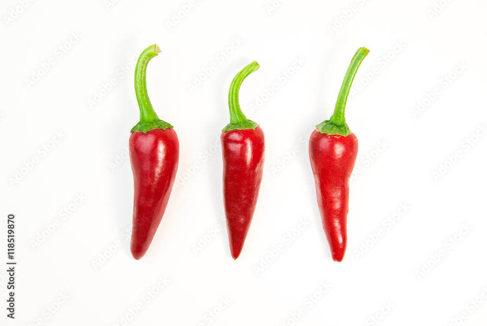 Three ripe red Chilli peppers on white