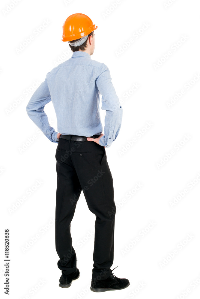 Backview of an engineer in construction helmet stands. Standing young guy. Rear view people collection. backside view of person. Isolated over white background. Curly businessman in a light jacket Backview of an engineer in construction helmet stands. Standing young guy. Rear view people collection. backside view of person. Isolated over white background. Curly businessman in a light jacket