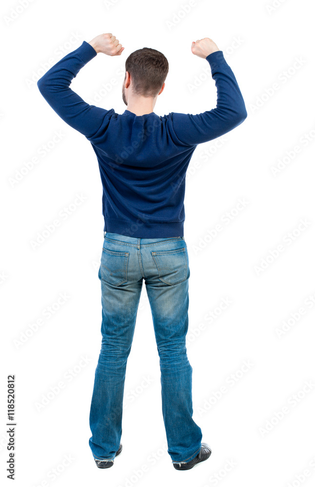 Back view of man. Raised his fist up in victory sign. Rear view people collection. backside view of person. Isolated over white background. bearded man in blue pullover happily waving their Back view of man. Raised his fist up in victory sign. Rear view people collection. backside view of person. Isolated over white background. bearded man in blue pullover happily waving their
