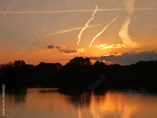 romantic sunset reflected in a lake water