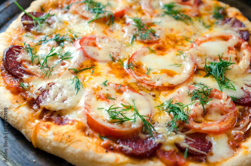 Close up of tasty pizza with chicken, tomato and cheese