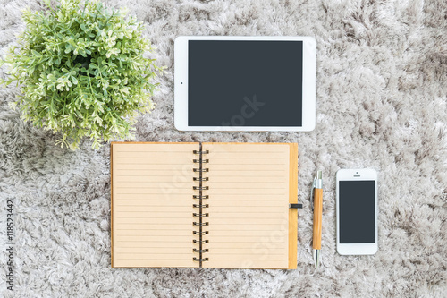 Wallpaper Mural Closeup brown note book , brown pen , computer notebook , tablet , phone and artificial plant on gray fabric capet textured background in top view in work concept Torontodigital.ca
