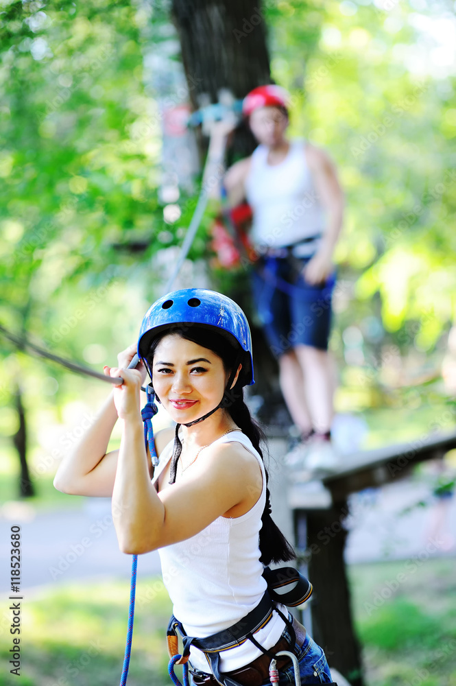 boy and girl climbing on rope road boy and girl climbing on rope road
